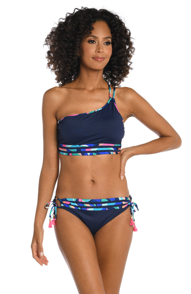 Model is wearing a bold paint-like stroke of vibrant dark colors printed on this one shoulder tankini top from our Painted Leaves collection!