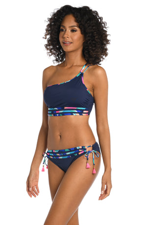 Model is wearing a bold paint-like stroke of vibrant dark colors printed on this one shoulder tankini top from our Painted Leaves collection!