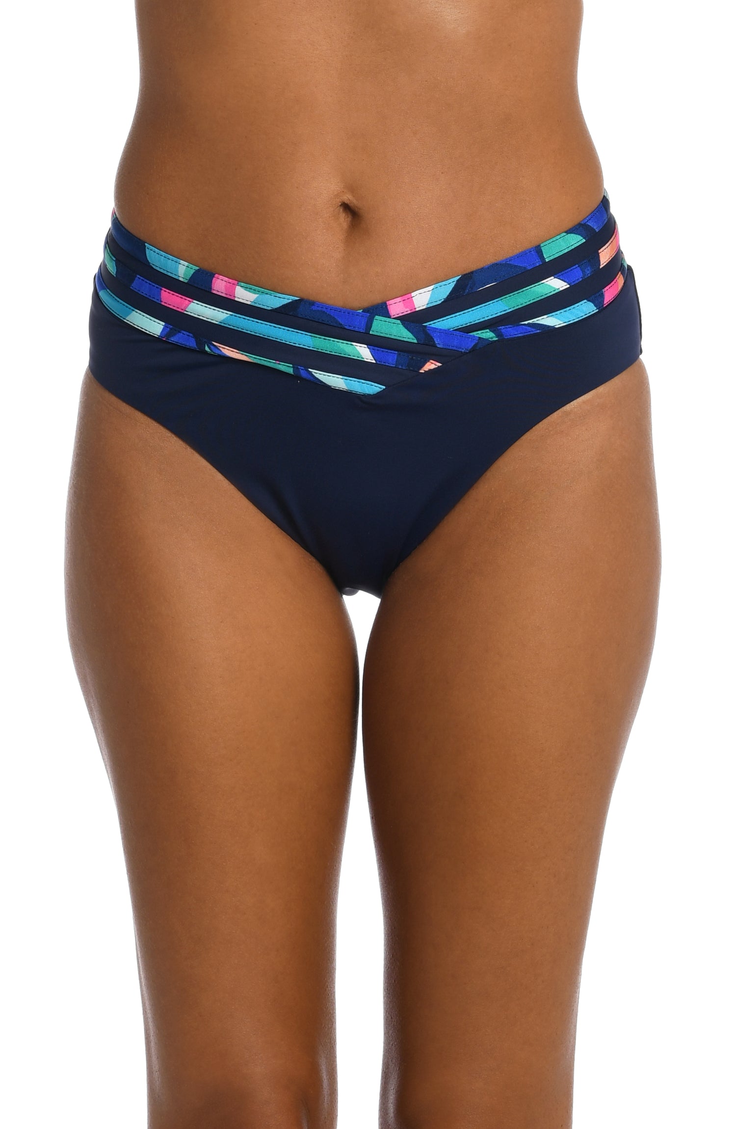 Model is wearing a bold paint-like stroke of vibrant dark colors printed on this crossover high waist bottom from our Painted Leaves collection!
