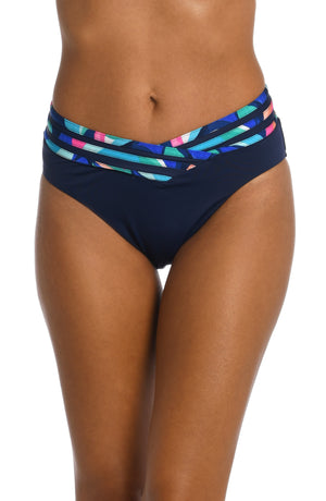 Model is wearing a bold paint-like stroke of vibrant dark colors printed on this crossover high waist bottom from our Painted Leaves collection!
