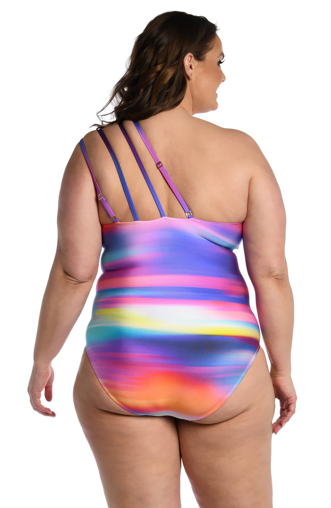 
            
                Load image into Gallery viewer, Model is wearing a multi colored ombre printed strappy one shoulder one piece from our Sunset Shores collection!
            
        