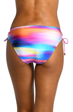 
            
                Load image into Gallery viewer, Model is wearing a multi colored ombre printed side tie hipster bottom from our Sunset Shores collection!
            
        