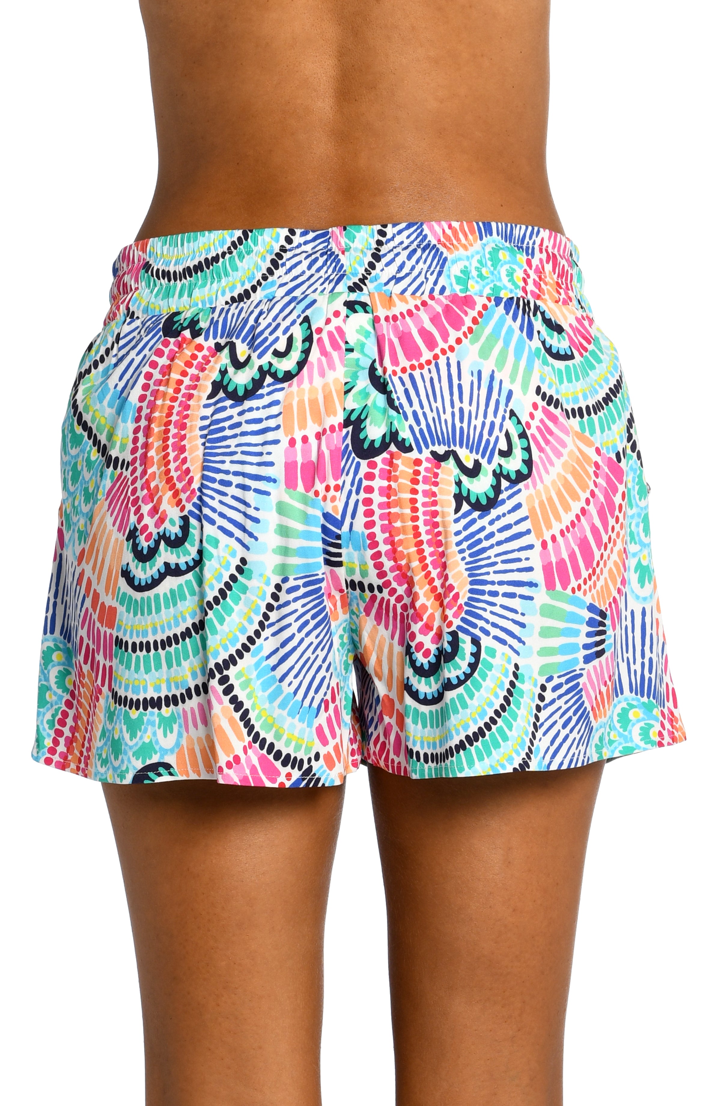Model is wearing a multi colored geometric printed beach shorts cover up from our Waves of Color collection!