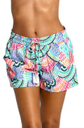 Model is wearing a multi colored geometric printed beach shorts cover up from our Waves of Color collection!