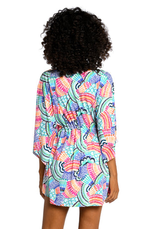 Model is wearing a multi colored geometric printed v-neck caftan cover up from our Waves of Color collection!