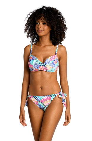 Model is wearing a multi colored geometric printed over the shoulder top from our Waves of Color collection!