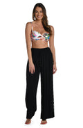 Model is wearing a crochet detailed pattern on this black palazzo pant cover up from out Coastal Covers collection!