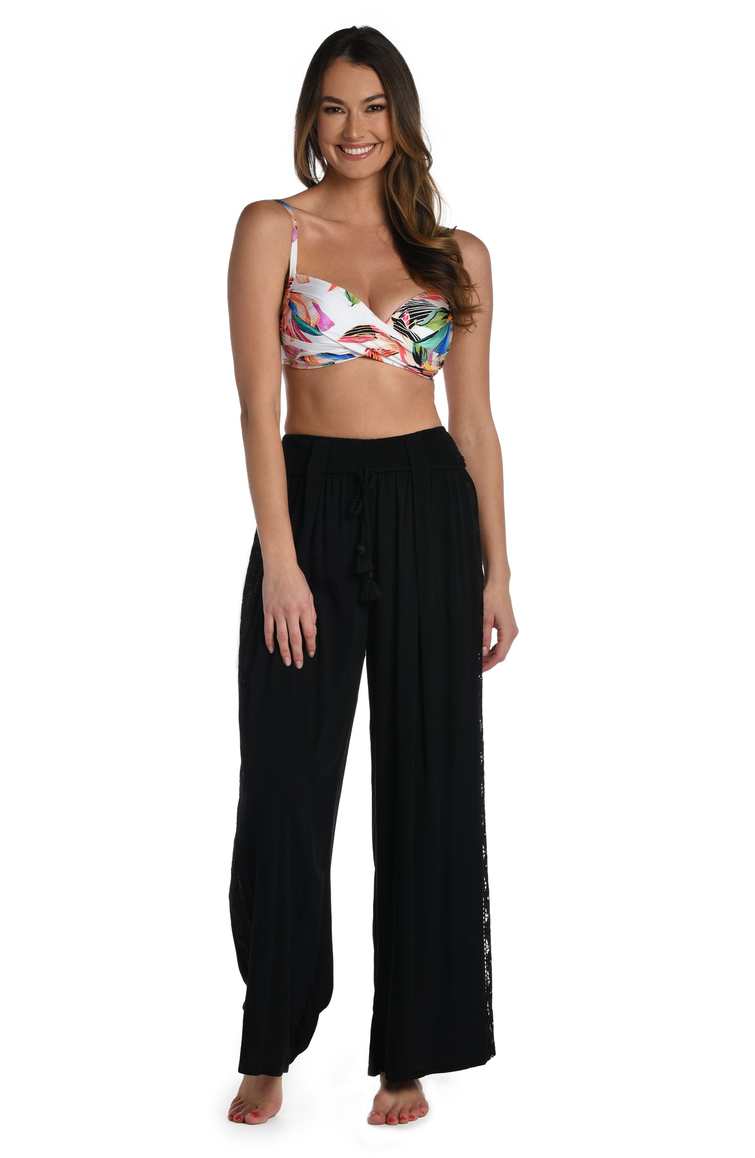 Model is wearing a crochet detailed pattern on this black palazzo pant cover up from out Coastal Covers collection!