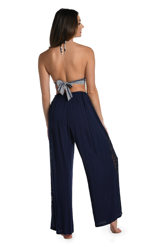 Model is wearing a crochet detailed pattern on this indigo palazzo pant cover up from out Coastal Covers collection!