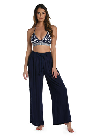 Model is wearing a crochet detailed pattern on this indigo palazzo pant cover up from out Coastal Covers collection!