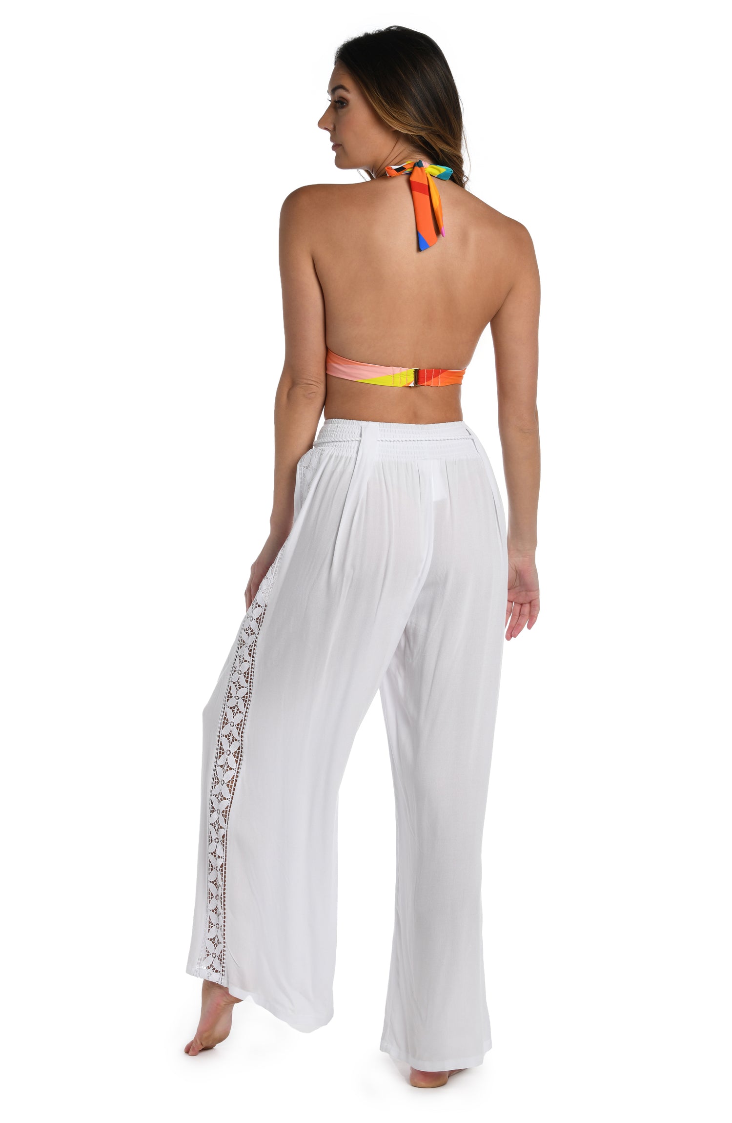 Model is wearing a crochet detailed pattern on this white palazzo pant cover up from out Coastal Covers collection!