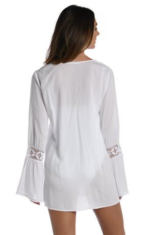 
            
                Load image into Gallery viewer, Model is wearing a crochet detailed pattern on this white v-neck tunic cover up from out Coastal Covers collection!
            
        