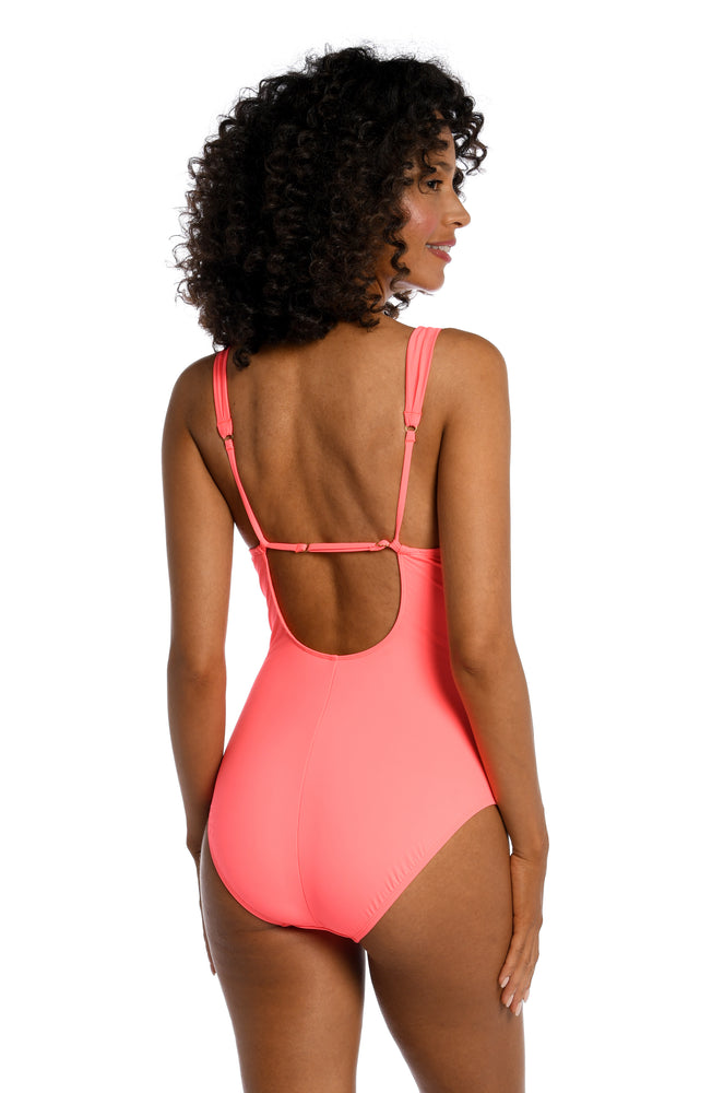Model is wearing a hot coral colored one piece swimsuit from our Best-Selling Island Goddess collection.