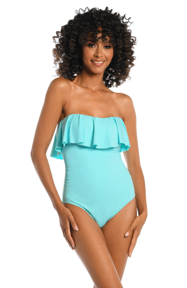 Model is wearing a ice blue colored bandeau one piece swimsuit from our Best-Selling Island Goddess collection.