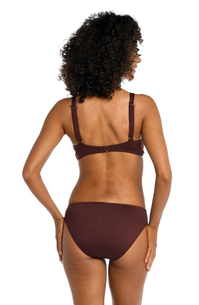 
            
                Load image into Gallery viewer, Model is wearing a solid brown colored twist front underwire bikini top from our Best-Selling Island Goddess collection.
            
        