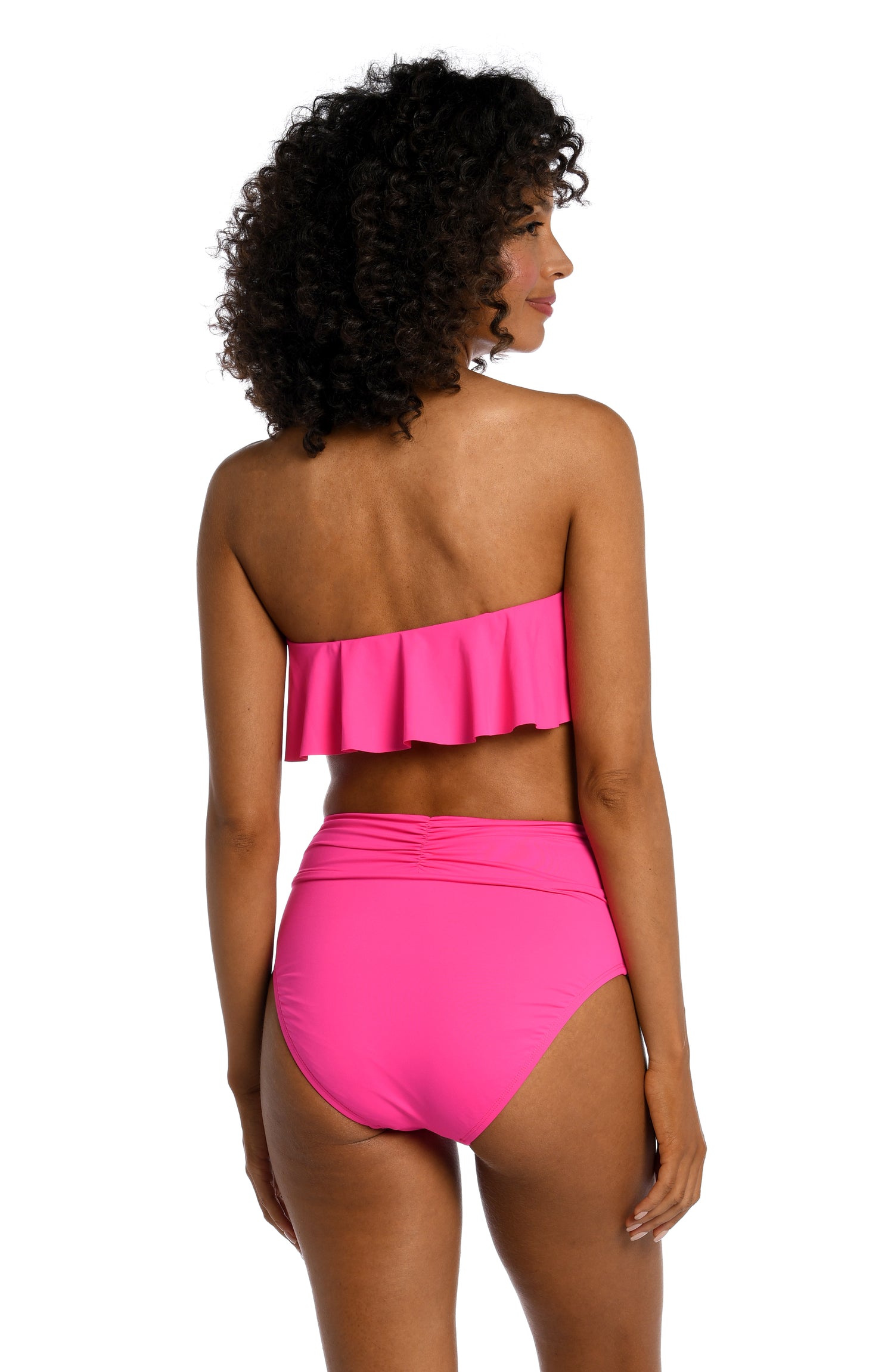 Model is wearing a pop pink colored ruffle bandeau swimsuit top from our Best-Selling Island Goddess collection.