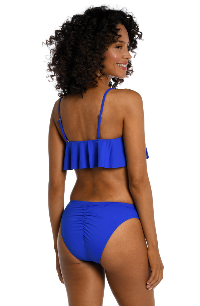 Model is wearing a sapphire colored ruffle bandeau swimsuit top from our Best-Selling Island Goddess collection.