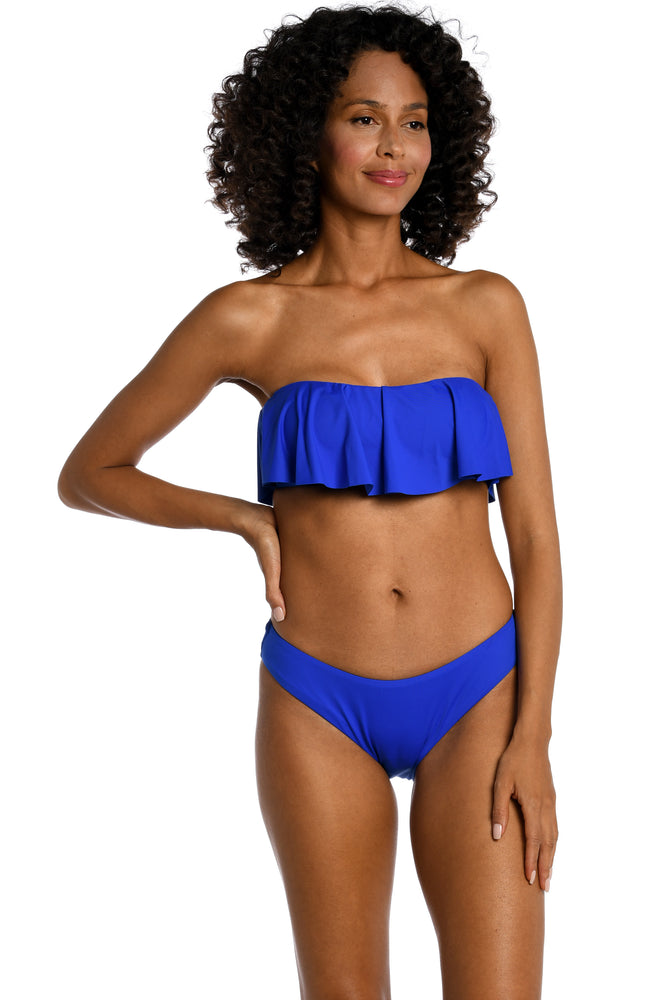 Model is wearing a sapphire colored ruffle bandeau swimsuit top from our Best-Selling Island Goddess collection.