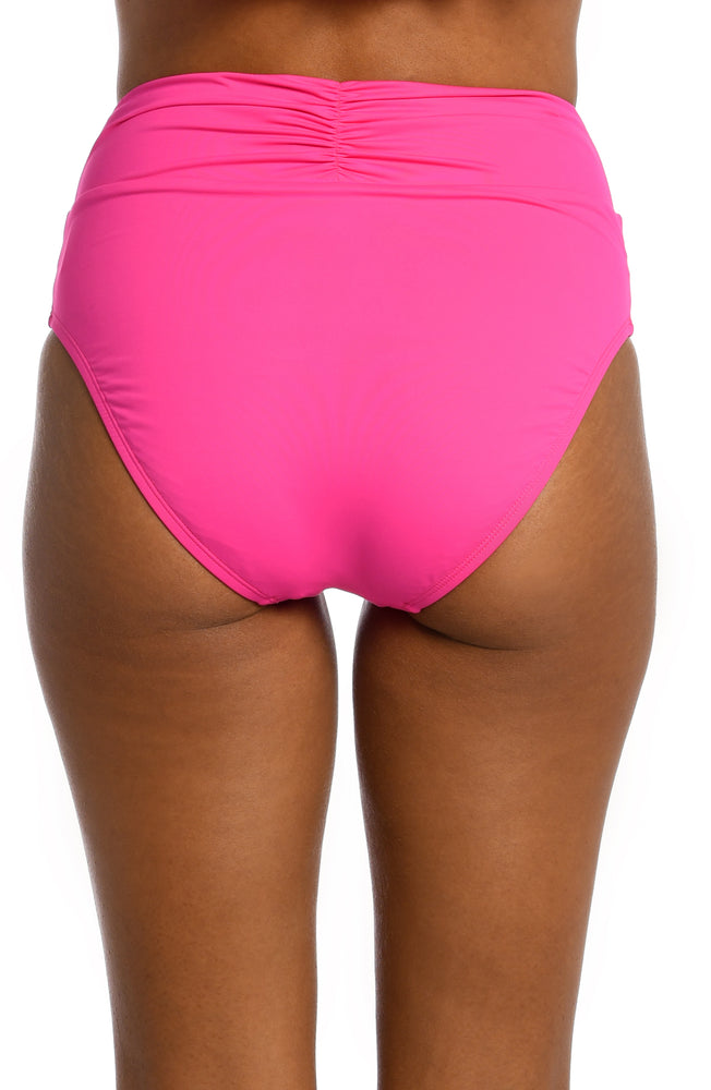 Model is wearing a pop pink colored high waist swimsuit bottom from our Best-Selling Island Goddess collection.