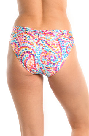 Model is wearing a pink multicolored paisley printed shirred band hipster bikini bottom from our Pebble Beach collection.