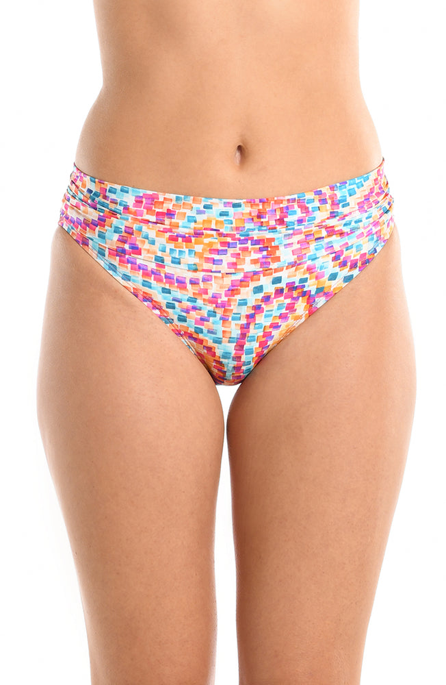 Model is wearing a pink multicolored paisley printed shirred band hipster bikini bottom from our Pebble Beach collection.