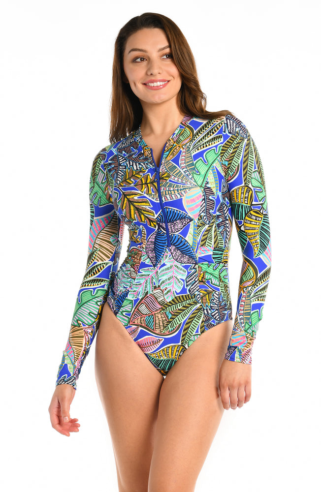 
            
                Load image into Gallery viewer, Model is wearing a neon colored printed long sleeve one piece swimsuit from our Neon Nights collection!
            
        