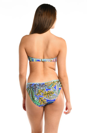 Model is wearing a neon colored tropical printed twist bandeau bikini top from our Neon Nights collection.