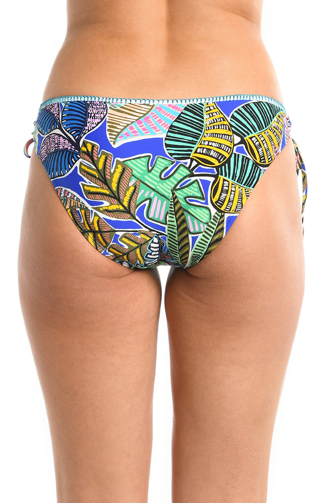 Model is wearing a neon colored tropical printed side tie hipster bikini bottom fom our Neon Nights collection.