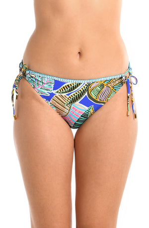 Model is wearing a neon colored tropical printed side tie hipster bikini bottom fom our Neon Nights collection.
