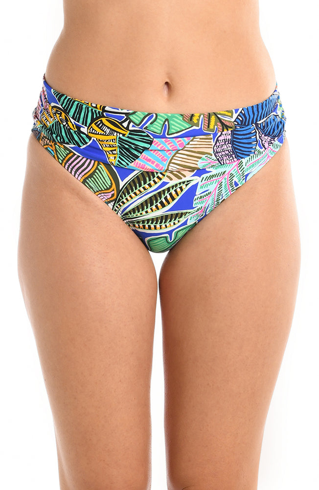 
            
                Load image into Gallery viewer, Model is wearing a neon colored tropical printed shirred band hipster bikini bottom from our Neon Nights collection.
            
        