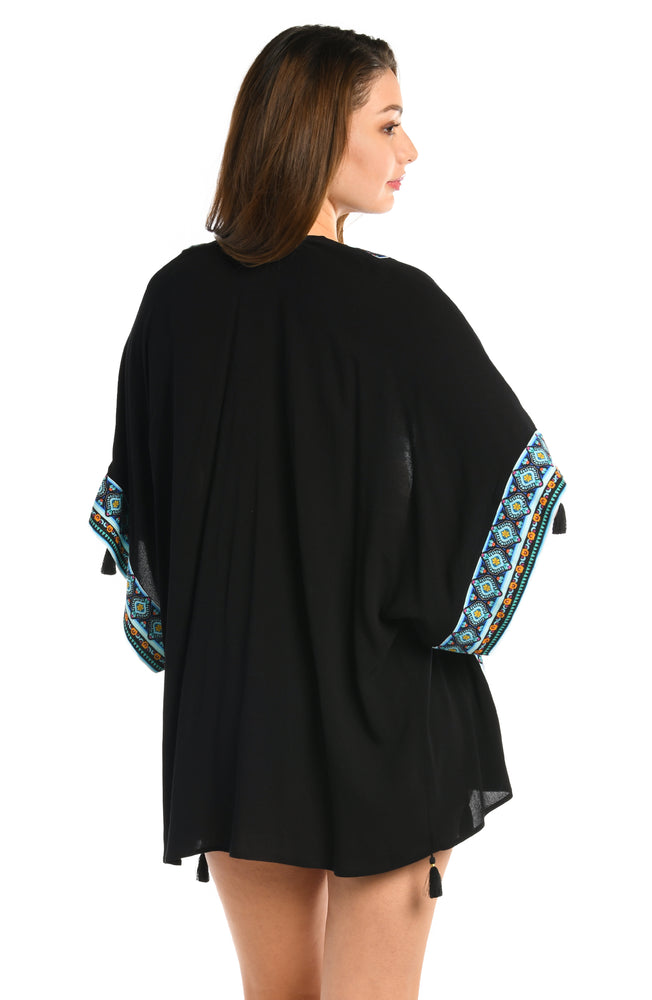 Model is wearing a black and aqua blue colored open front kimono cover up from our Running Wild collection.