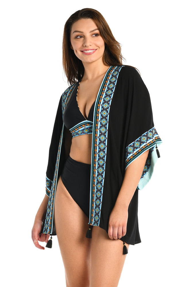 Model is wearing a black and aqua blue colored open front kimono cover up from our Running Wild collection.