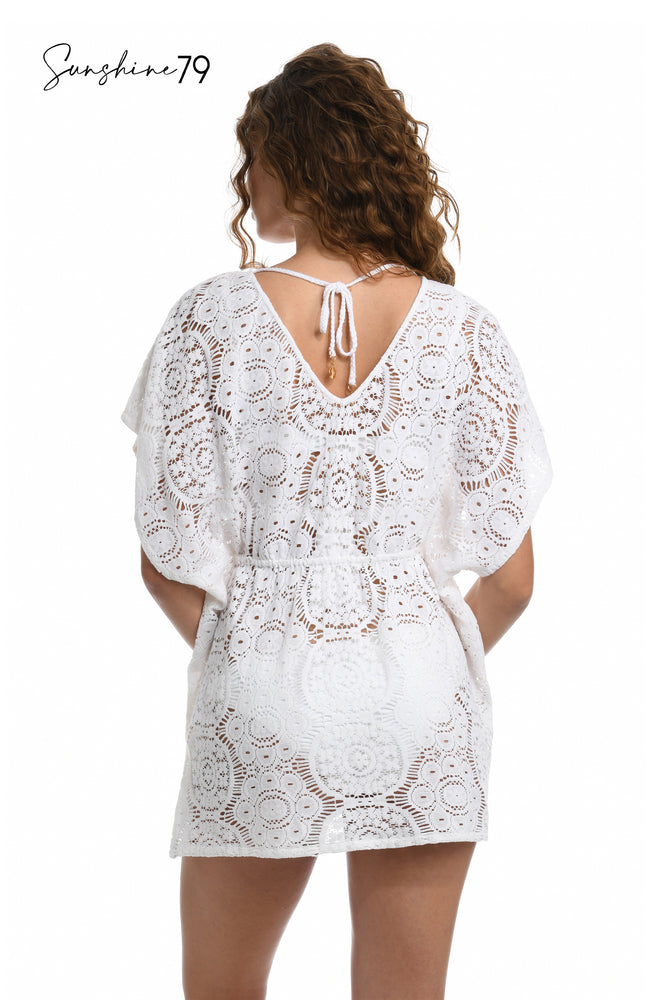 Model is wearing a white crochet v neck caftan cover up from our Sunshine 79 brand. 