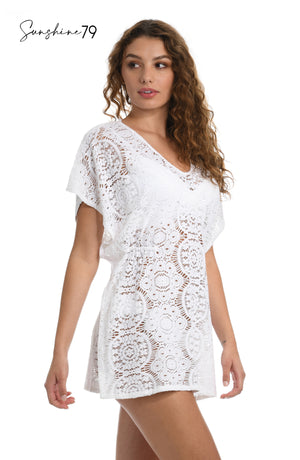 Model is wearing a white crochet v neck caftan cover up from our Sunshine 79 brand. 