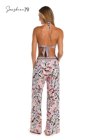 Model is wearing a pink multicolored paisley printed beach pant cover up from our Sunshine 79 brand.