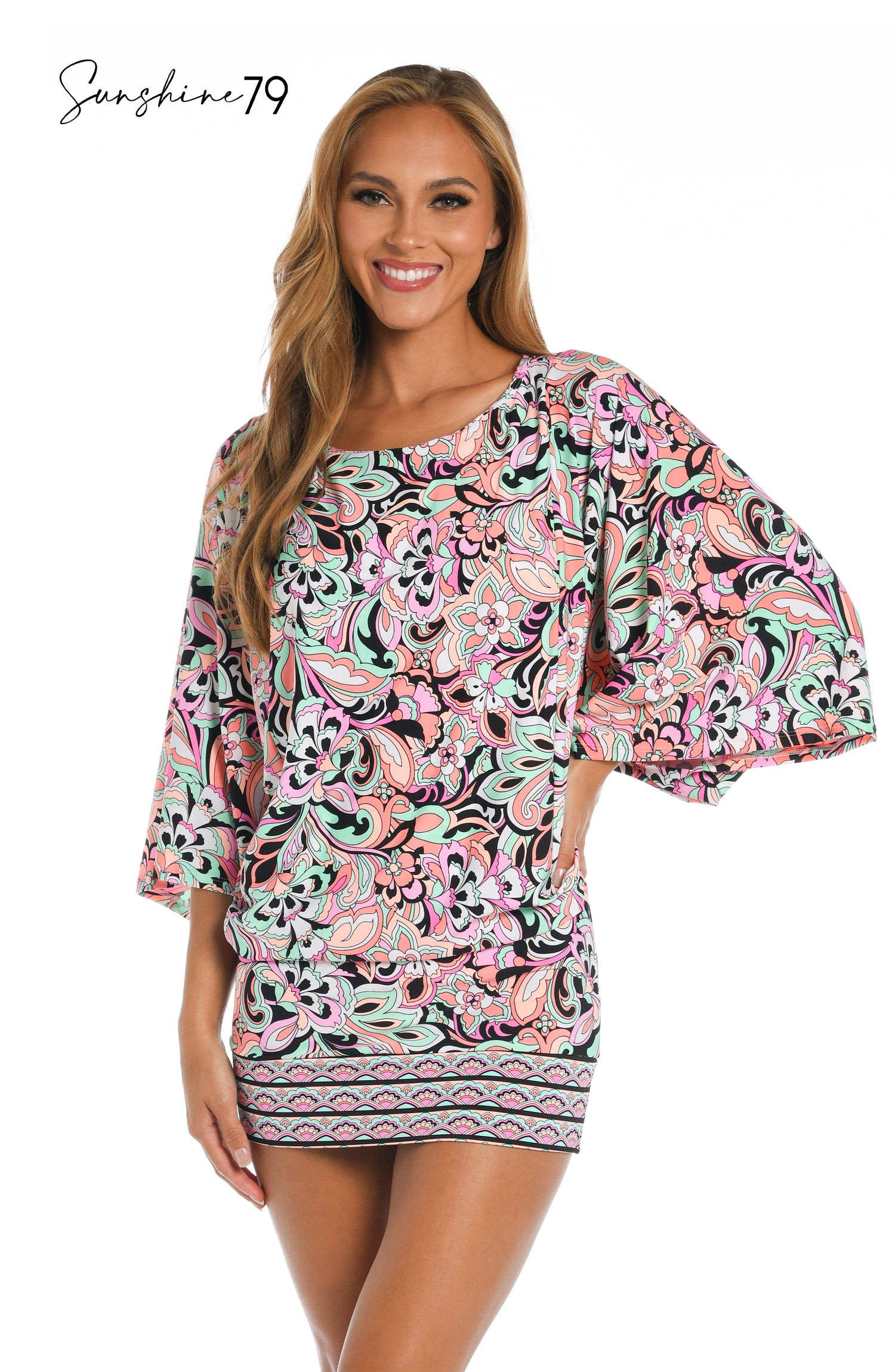 Model is wearing a pink multicolored paisley printed scoop neck tunic cover up from our Sunshine 79 brand.