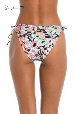 
            
                Load image into Gallery viewer, Model is wearing a pink multicolored paisley printed string tie side hipster bikini bottom from our Sunshine 79 brand.
            
        
