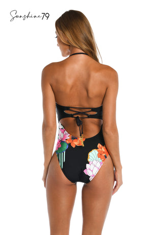 
            
                Load image into Gallery viewer, Model is wearing a black multi colored tropical printed bandeau one piece from our Mystic Lotus collection!
            
        