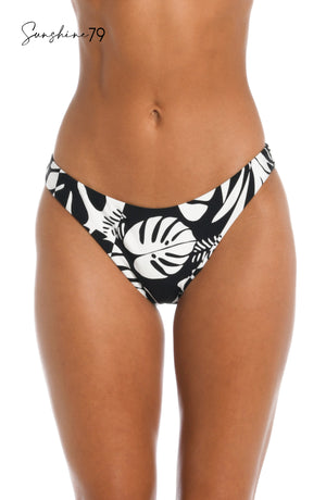 Model is wearing a black and white multi colored tropical printed high leg hipster bottom from our Optic Tropic collection!