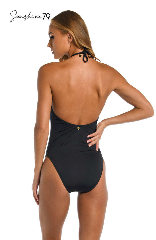 Model is wearing a solid black high neck one piece from our Sunshine 79 brand.