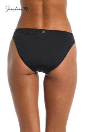 
            
                Load image into Gallery viewer, Model is wearing a solid black side shirred hipster bottom from our Sunshine 79 brand.
            
        