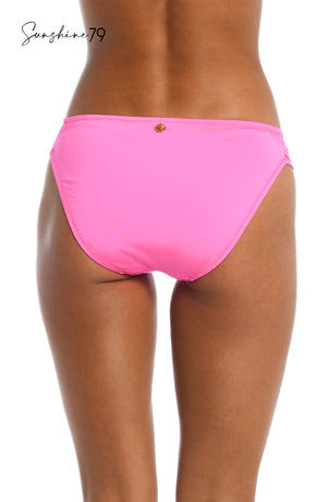 
            
                Load image into Gallery viewer, Model is wearing a solid hot pink side shirred bikini bottom from our Sunshine 79 brand.
            
        