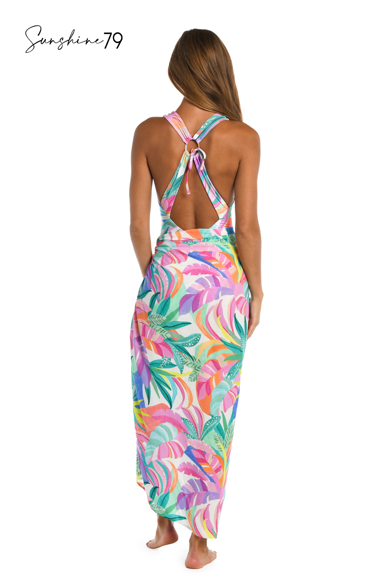 Model is wearing a multi colored tropical printed pareo cover up wrap from our Sunshine 79 brand.
