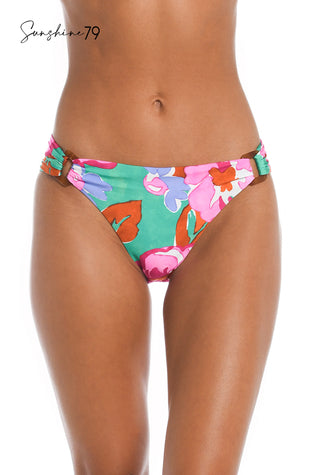 Model is wearing a bright multicolored floral printed ring-side hister bottom from our Sunshine 79 brand.