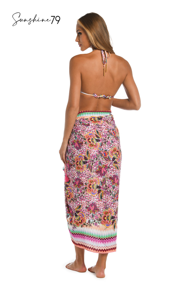
            
                Load image into Gallery viewer, Model is wearing a pink multicolored floral and striped printed pareo wrap cover up from our Sunshine 79 brand.
            
        