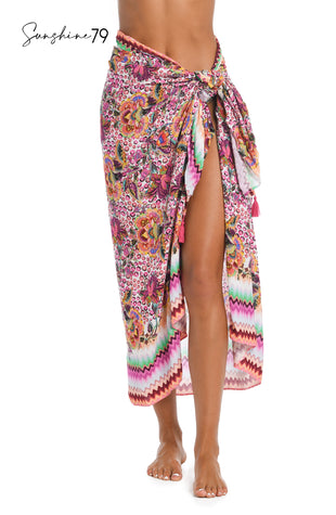 Model is wearing a pink multicolored floral and striped printed pareo wrap cover up from our Sunshine 79 brand.
