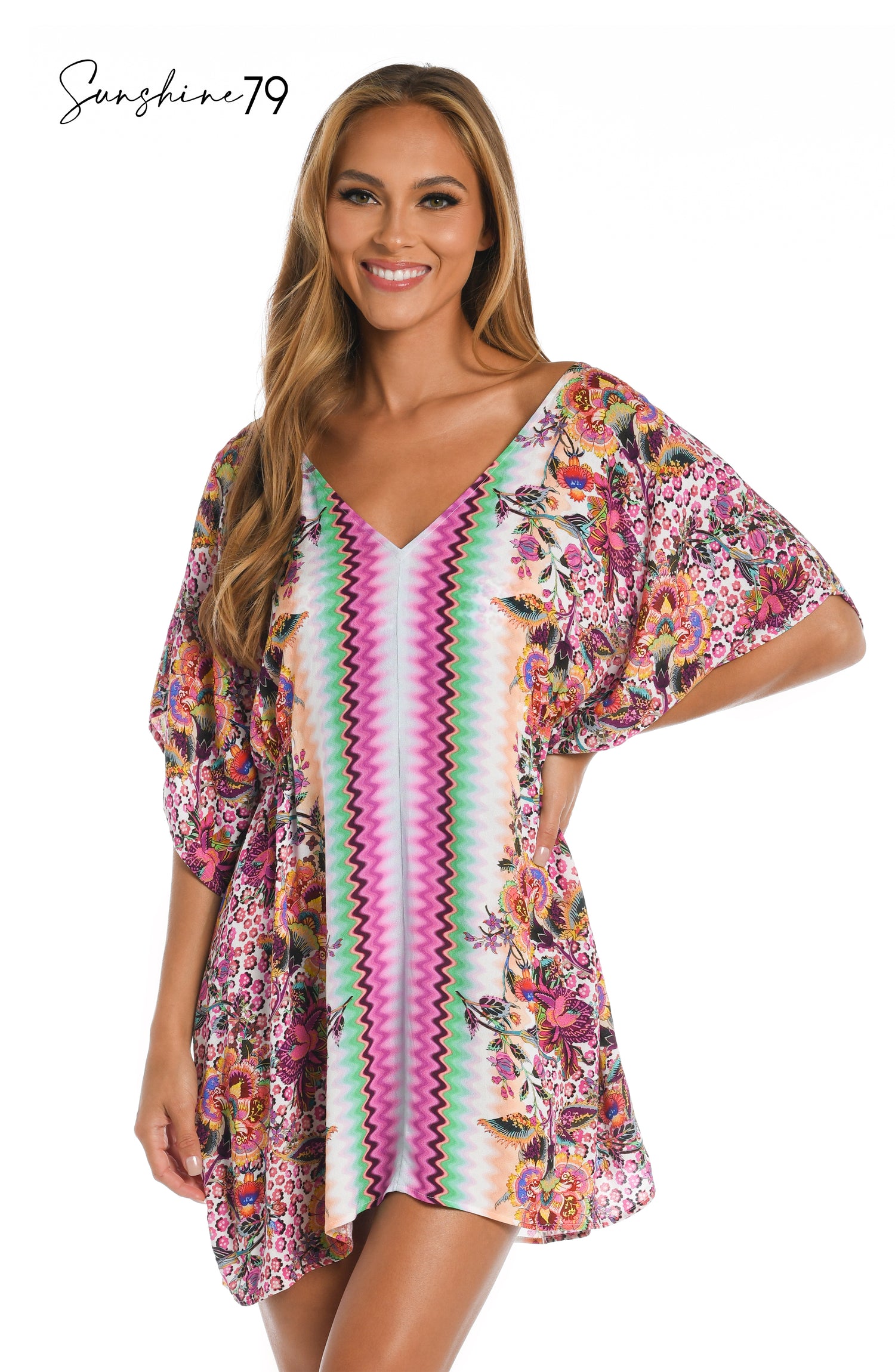 Model is wearing a pink multicolored floral and striped printed v neck caftan cover up from our Sunshine 79 brand.