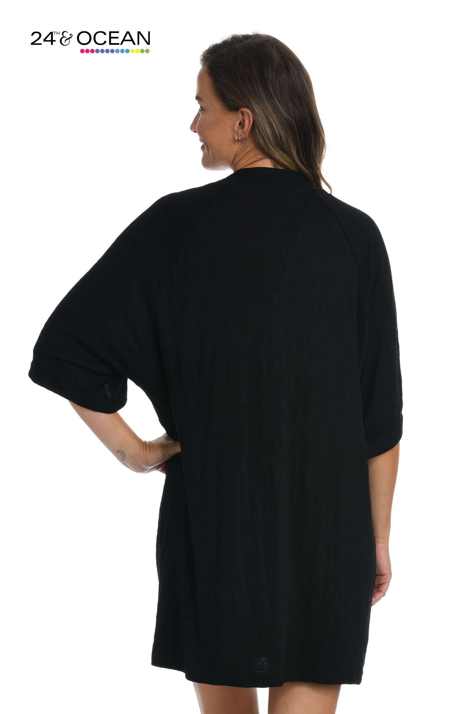 Model is wearing a solid black colored lace front tunic cover up from our 24th & Ocean brand.