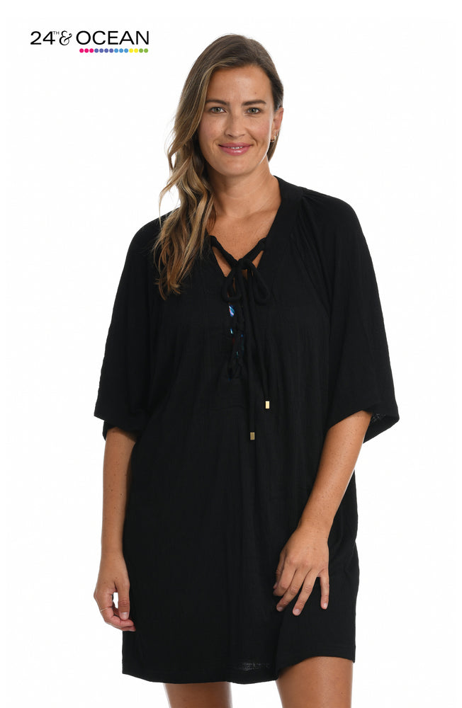 Model is wearing a solid black colored lace front tunic cover up from our 24th & Ocean brand.