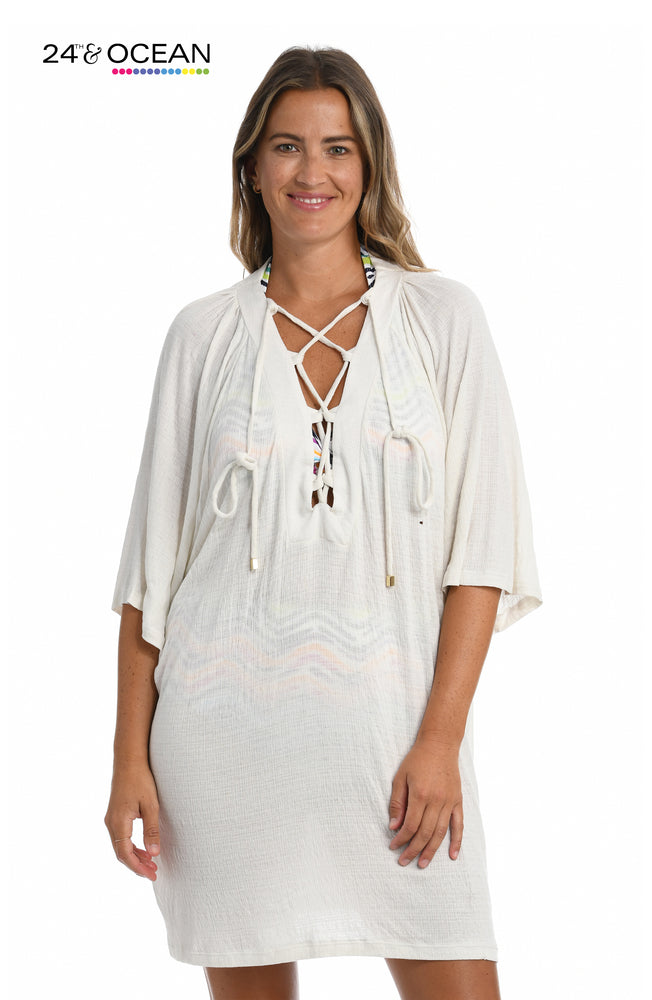 Model is wearing a solid white colored lace front tunic cover up from our 24th & Ocean brand.